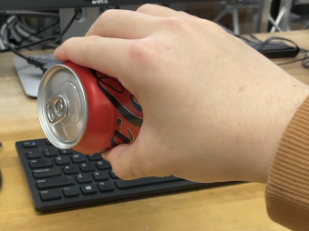 Hand grasping the can in the video
